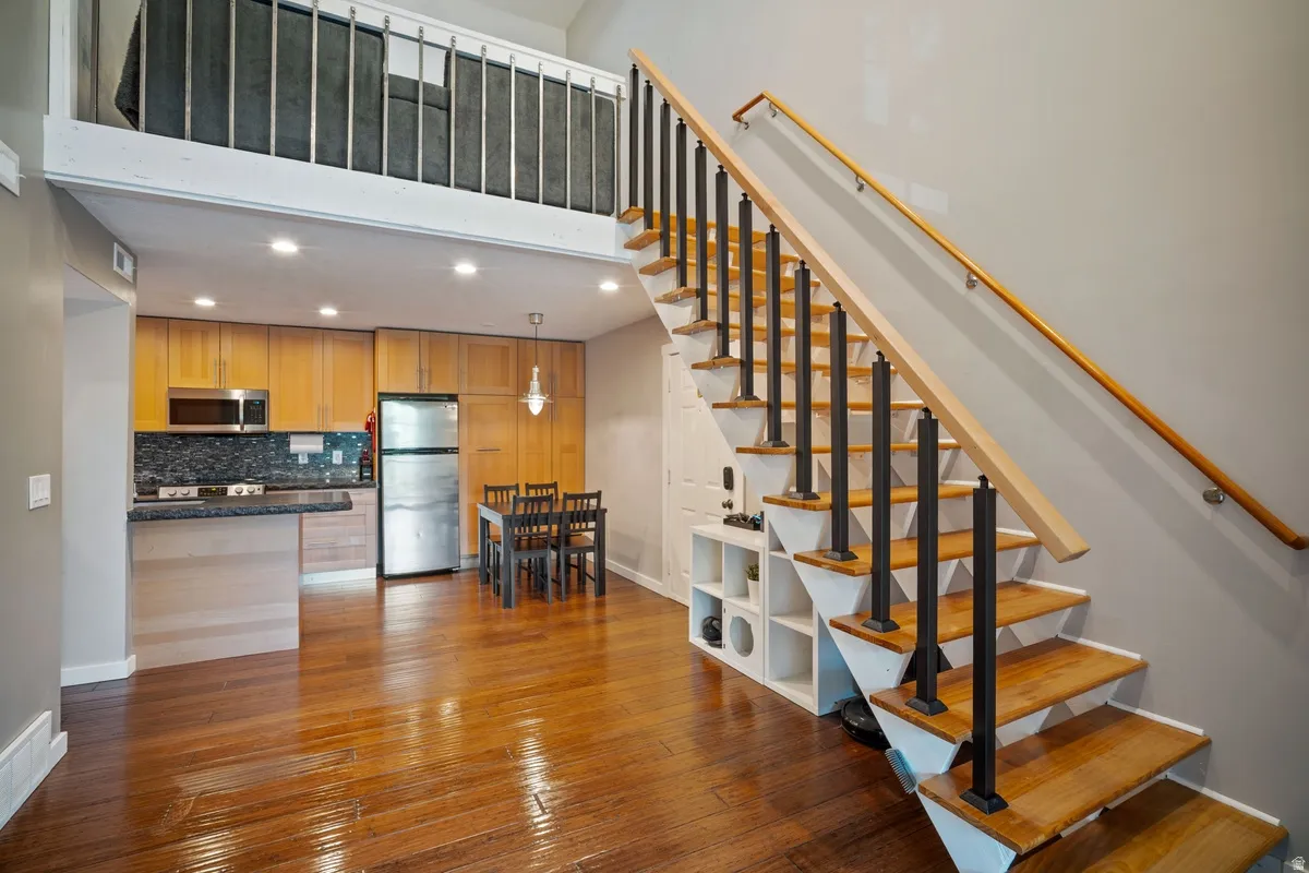 Open-concept living space with lustrous wood-finish flooring