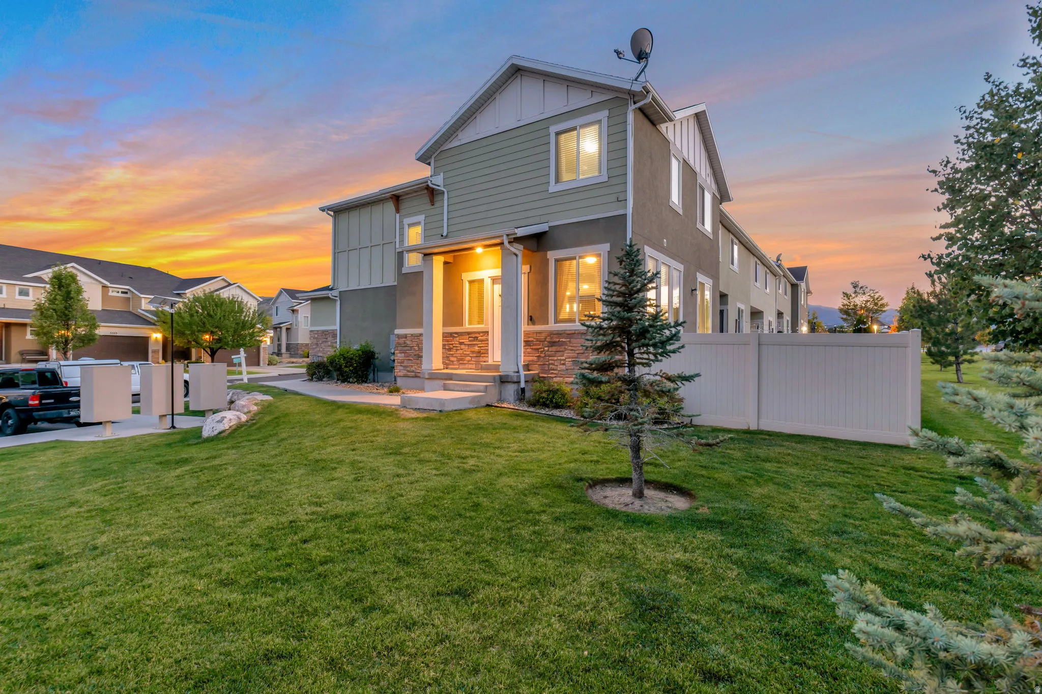 Two-story townhome featuring a stone and siding exterior