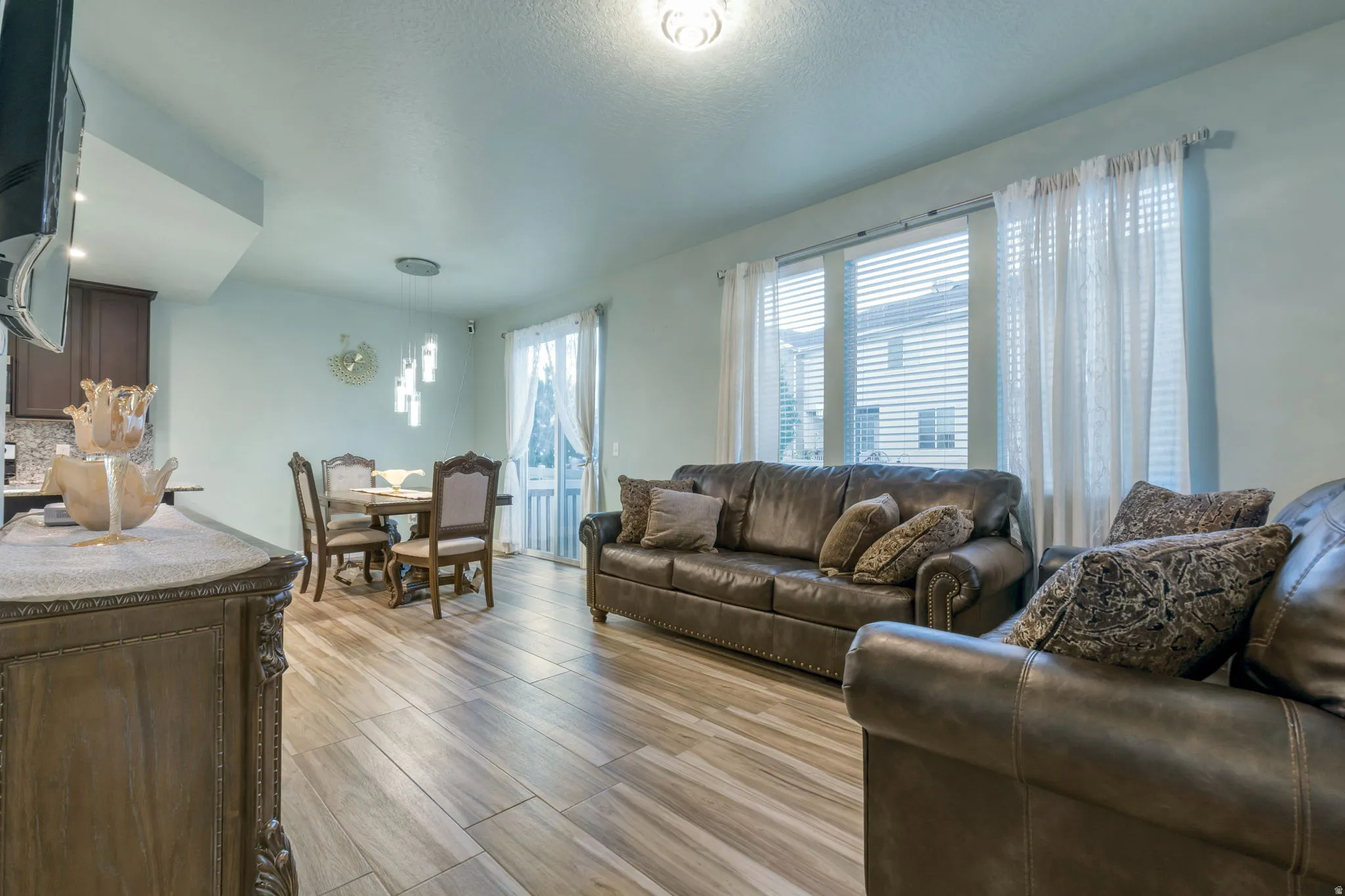 Open-concept living space featuring wood-finish flooring throughout