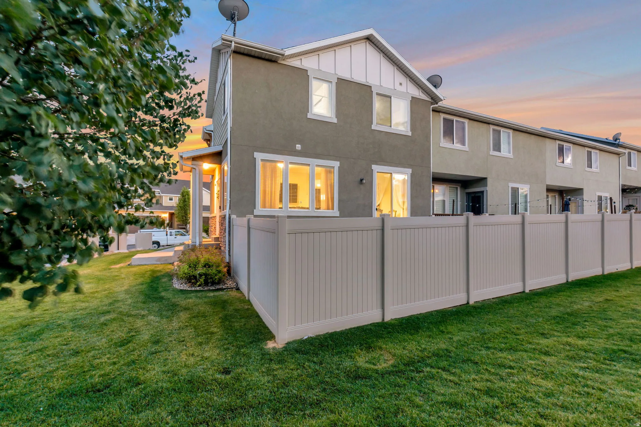 Green lawn area featuring a full-height privacy fence