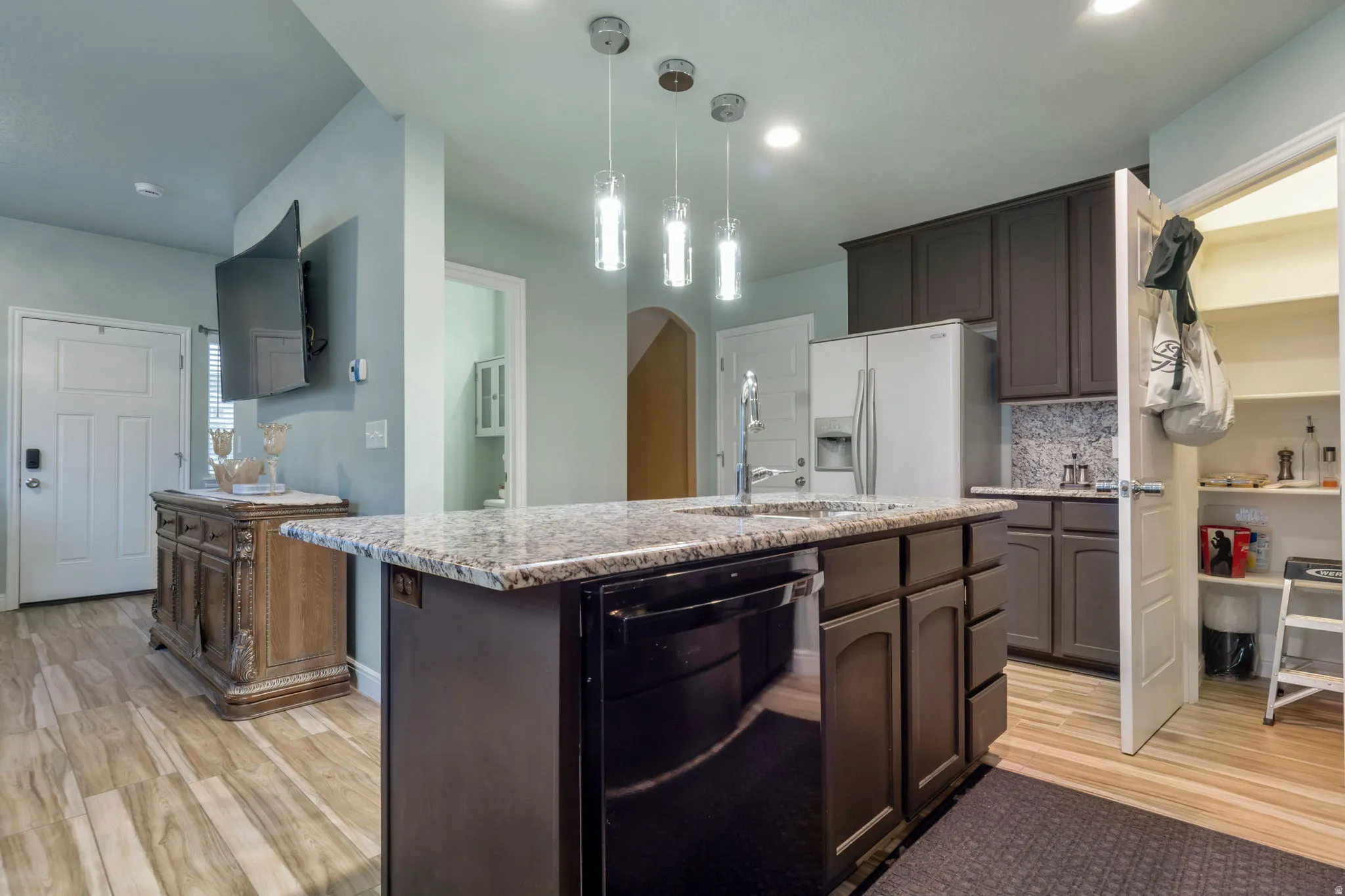 Kitchen island with granite-finish countertop and undermount sink