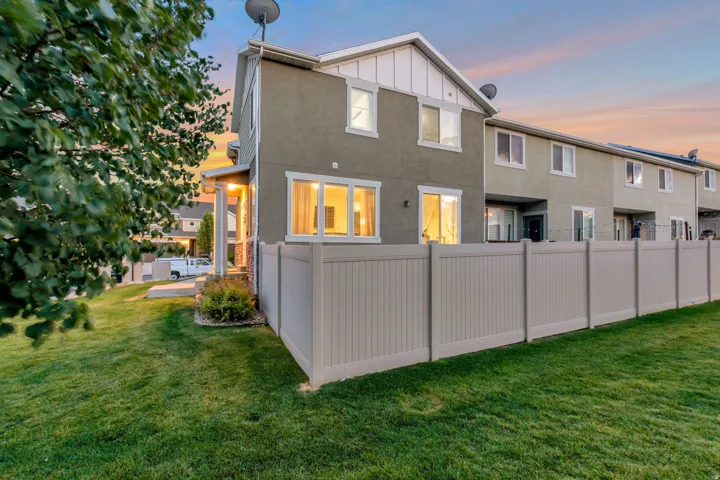 Green lawn area featuring a full-height privacy fence