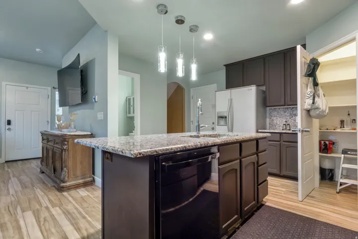 Kitchen island with granite-finish countertop and undermount sink