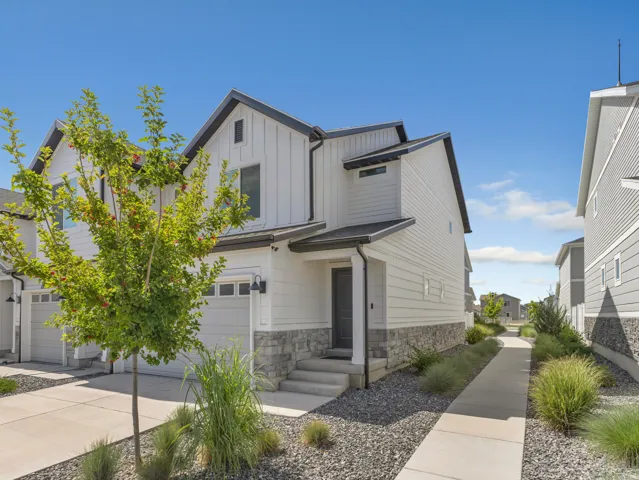 Modern-style residence featuring white siding and dark trim accents