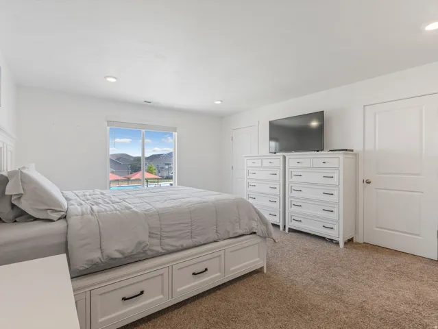 Bright interior space featuring recessed lighting and carpeted flooring