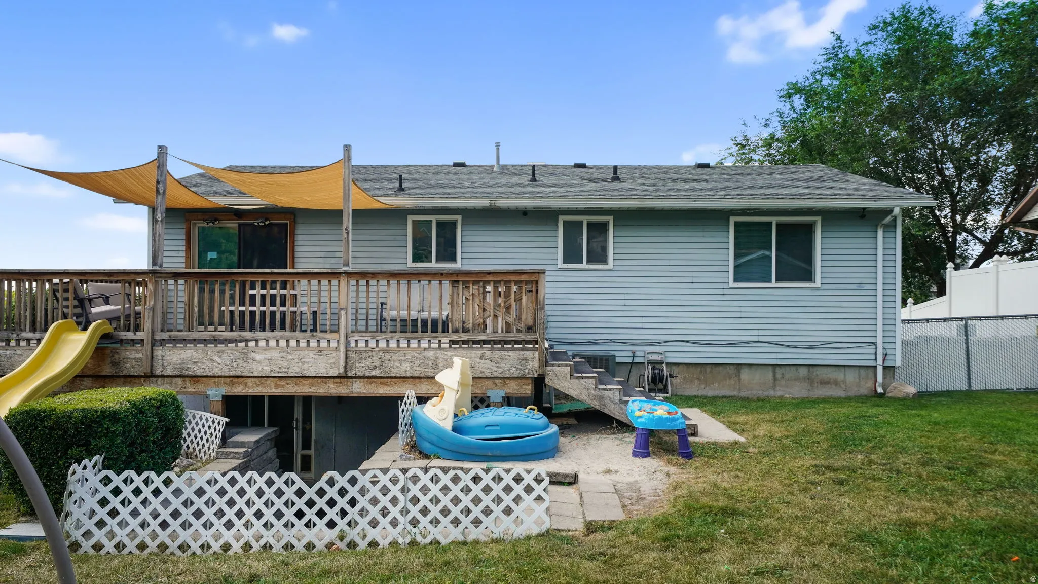 Back of house showing huge deck and covered patio beneath