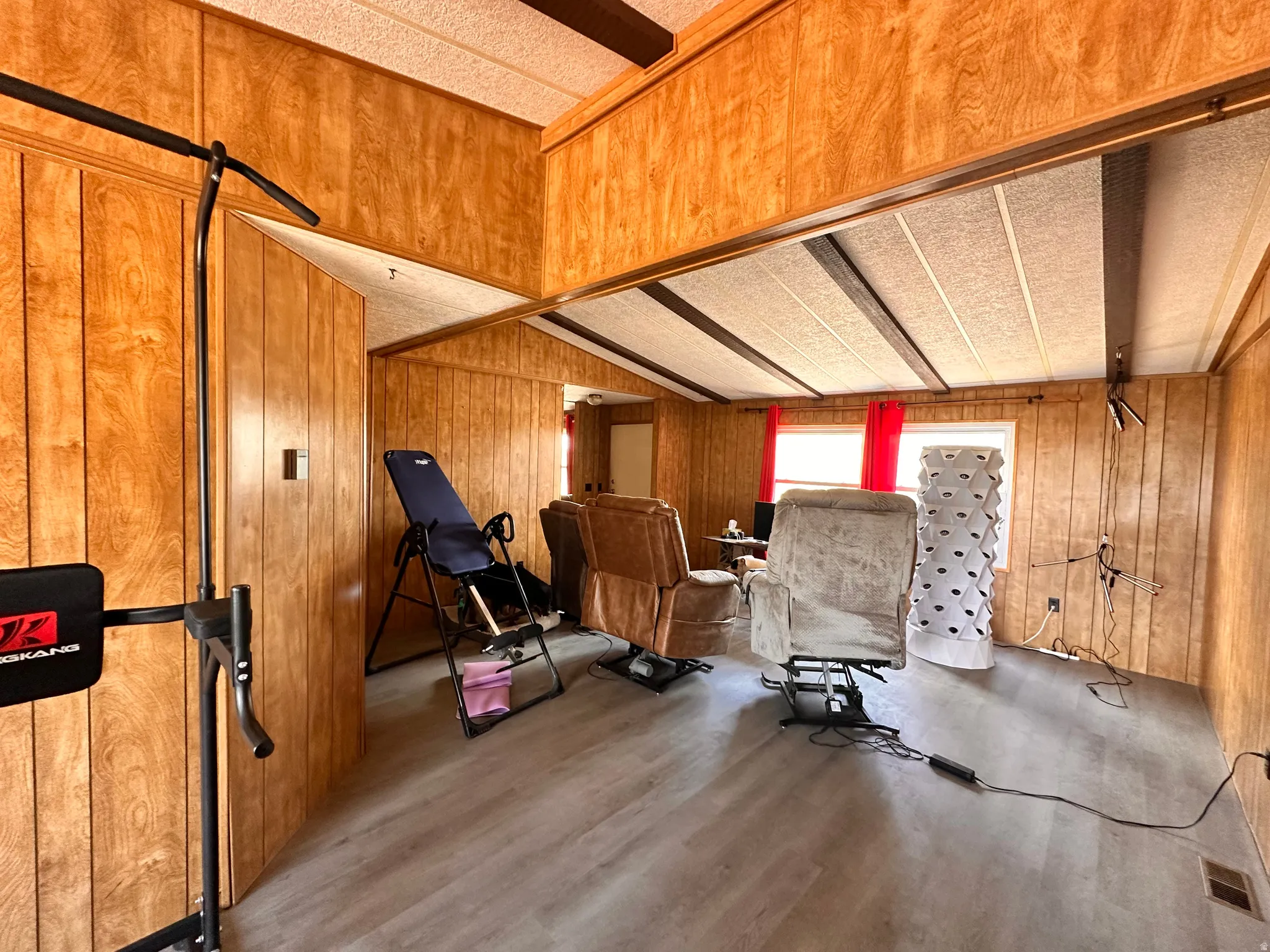 Interior room featuring wood-panel walls and wood-finish flooring