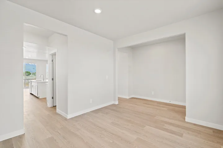 Open-concept living space featuring light wood-finish flooring and recessed ceiling lighting