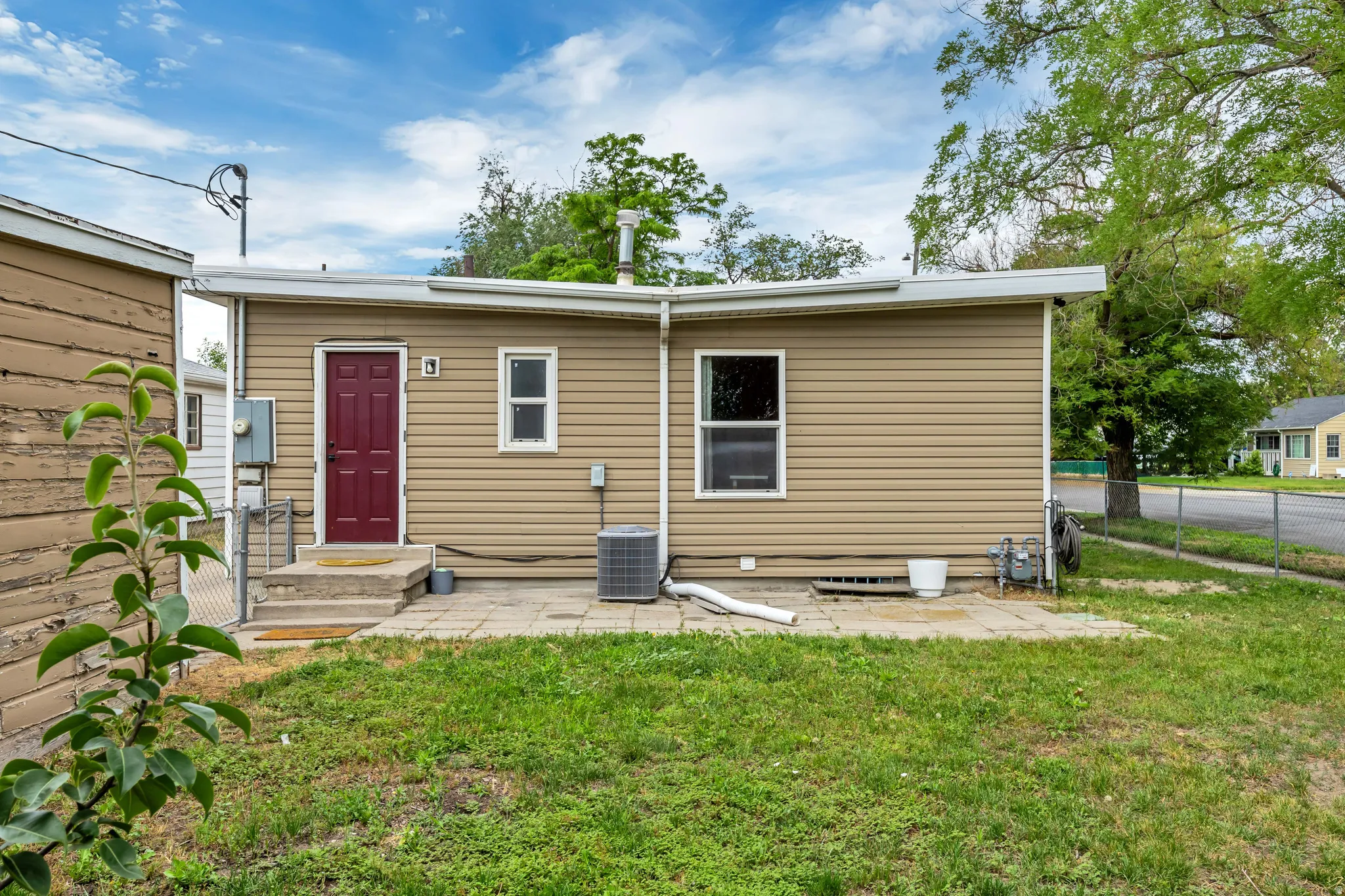 Rear exterior with tan horizontal siding