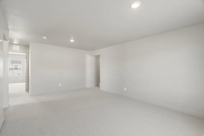 **DISCLAIMER** Interior package may vary. Spacious room with light-toned wall finishes and soft carpet flooring