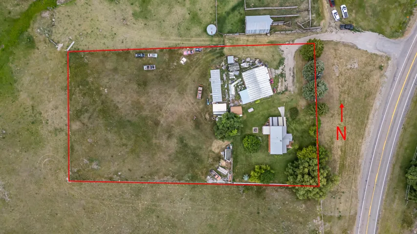 Aerial view showcasing a large lot with defined property boundaries