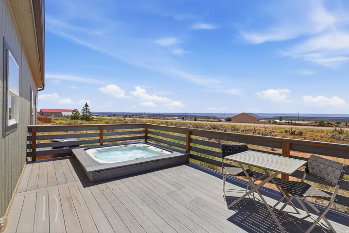 Expansive outdoor trex deck featuring a built-in hot tub.