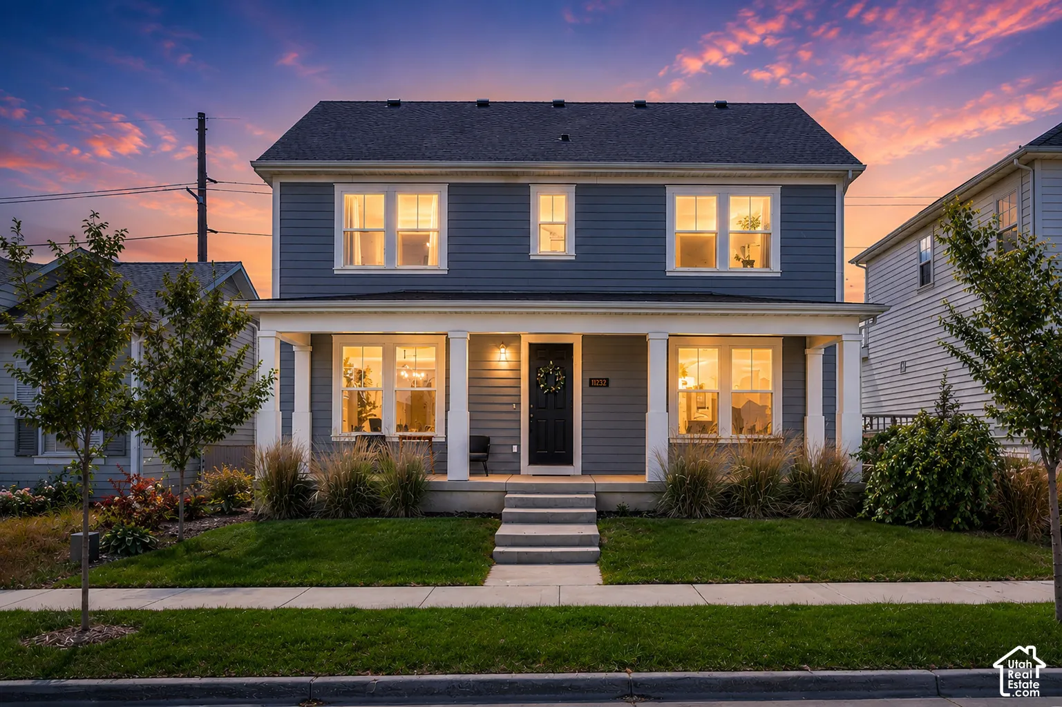 Two-story residence featuring blue siding, white trim, and a dark shingle roof