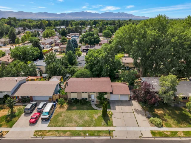 Residential property with an expansive front lawn and a dual-car driveway leading to an attached garage