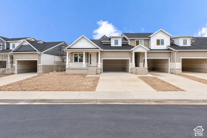 Multi-family exterior featuring a neutral stucco and lap siding fa