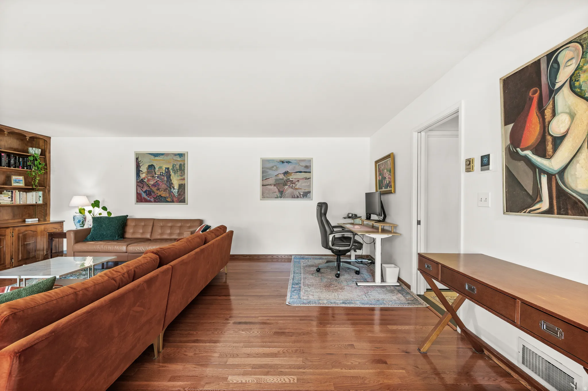 Open-concept living area featuring wood-finish flooring throughout