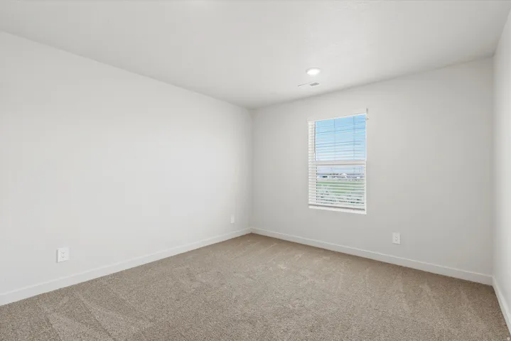 **DISCLAIMER** Interior package may vary. Neutral tone carpet flooring with white baseboards and walls