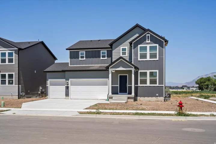 Contemporary two-story residence featuring a dark gray and light gray exterior with white trim