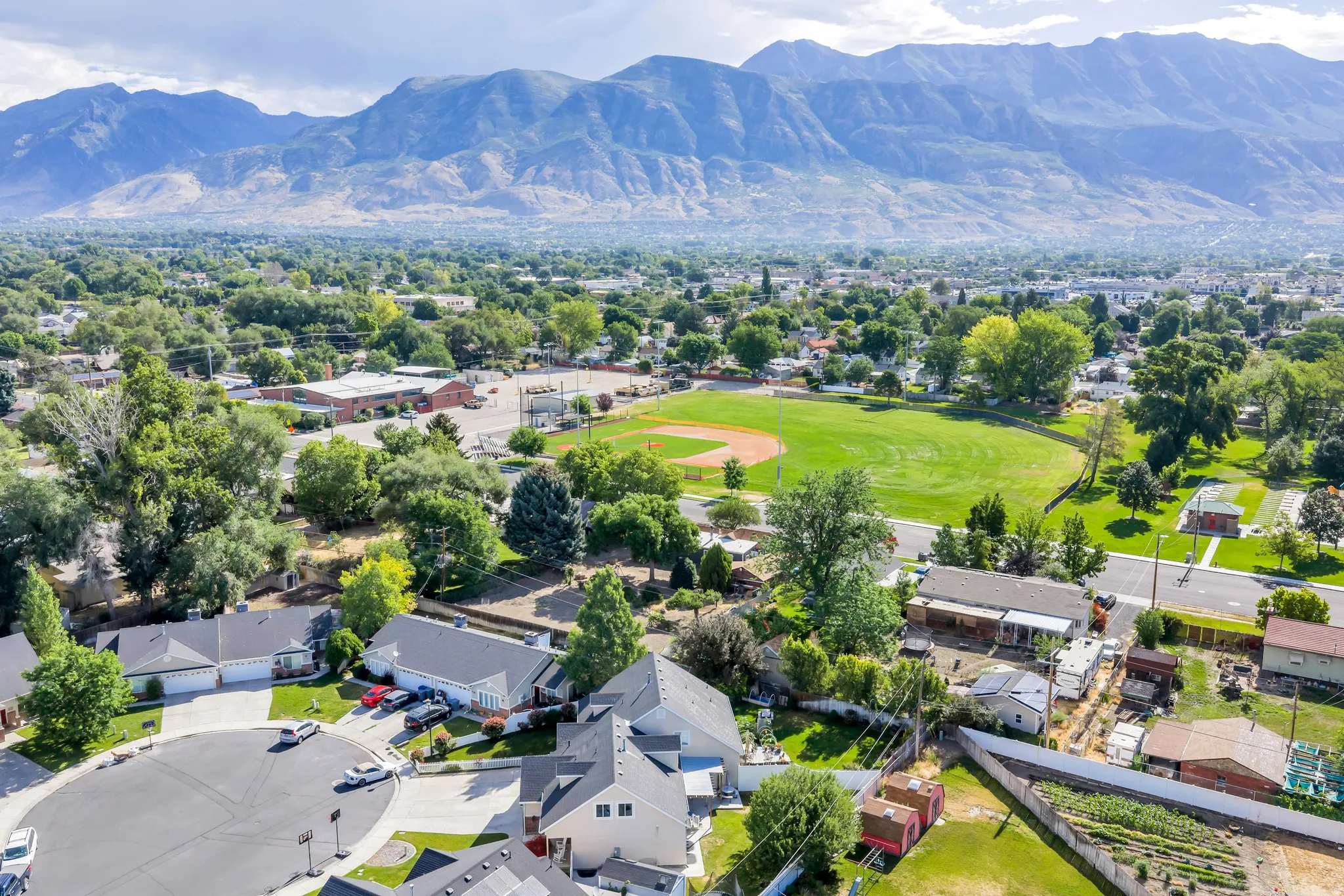 Expansive mountain range backdrop and neighborhood setting