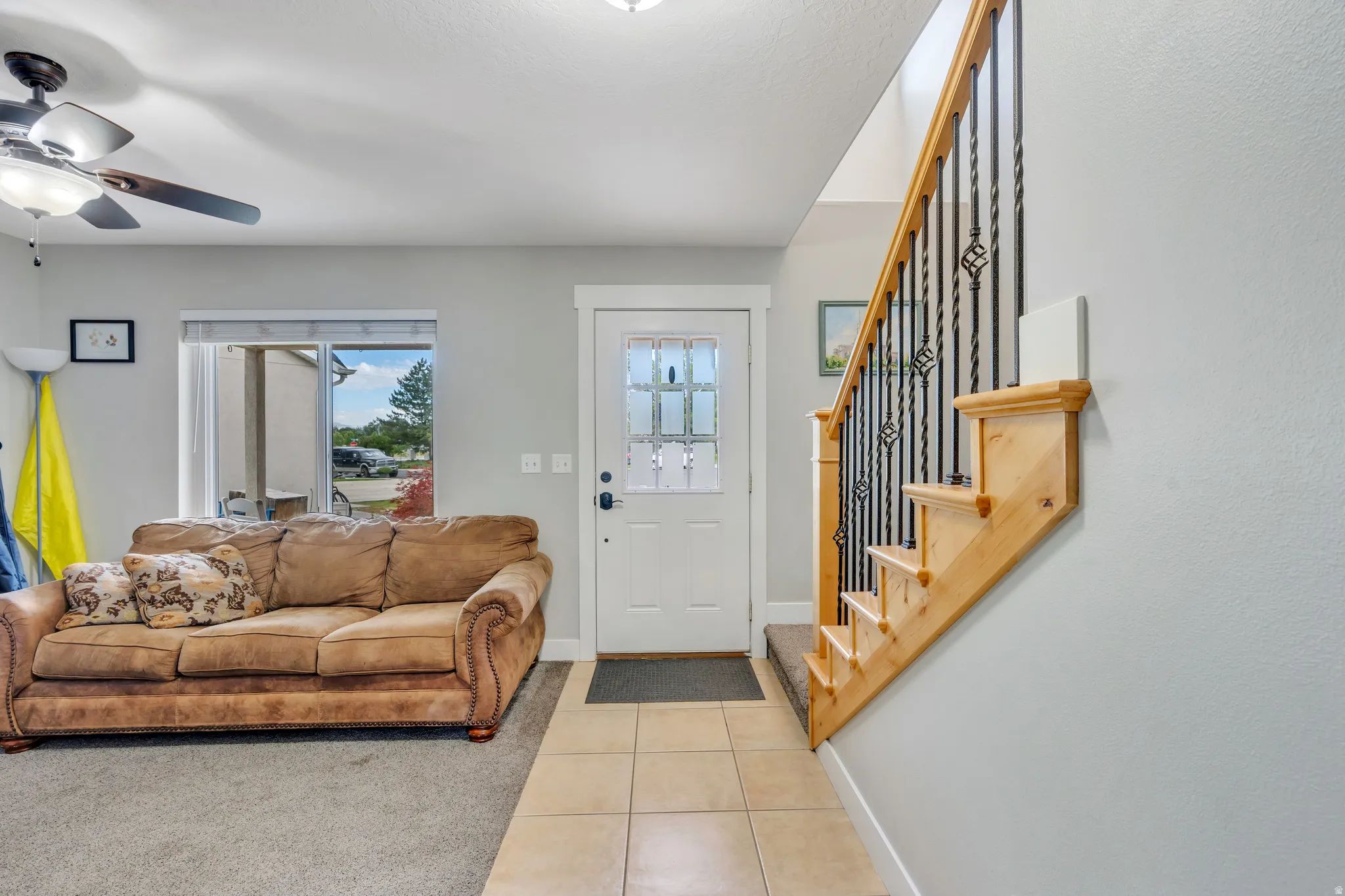 Entryway featuring tile flooring leading to carpeted living space