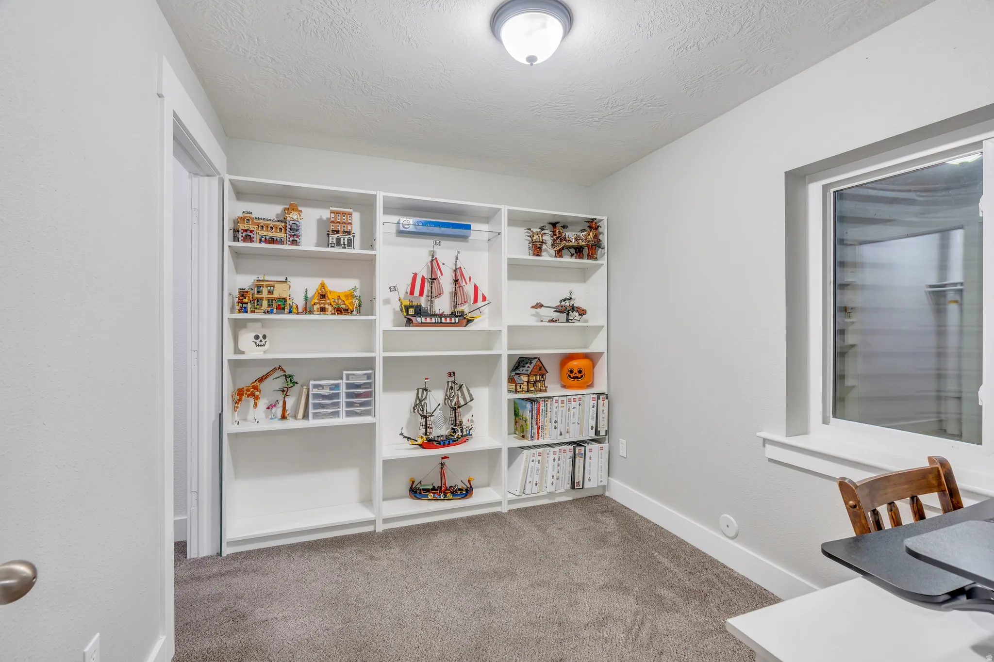 Custom built-in shelving provides extensive storage and display options