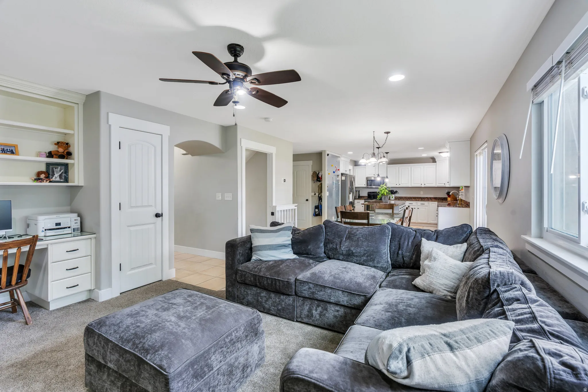 Open-concept living area with integrated kitchen beyond