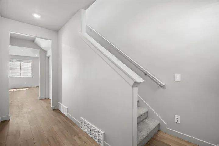 Entryway featuring wood-finish flooring extending into an open room