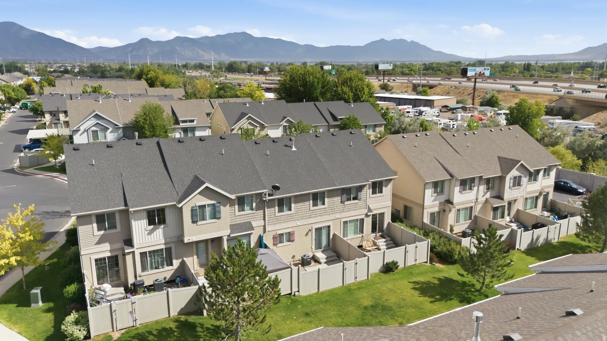 Townhome exterior with shingle roofing and mountain scenery