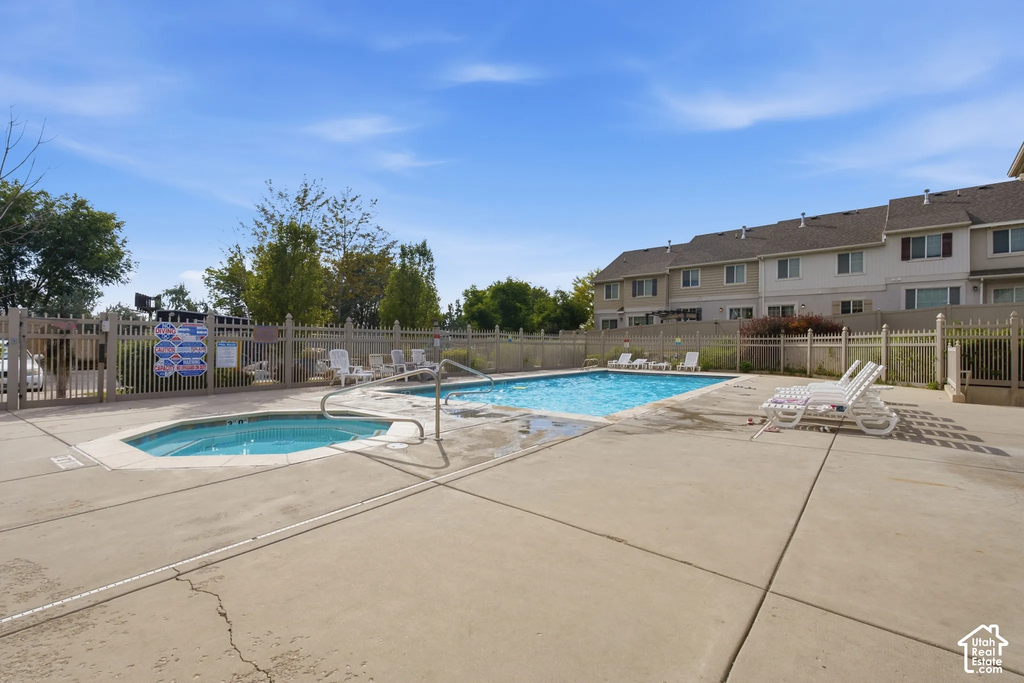 Outdoor amenity space featuring a rectangular swimming pool and an adjacent spa