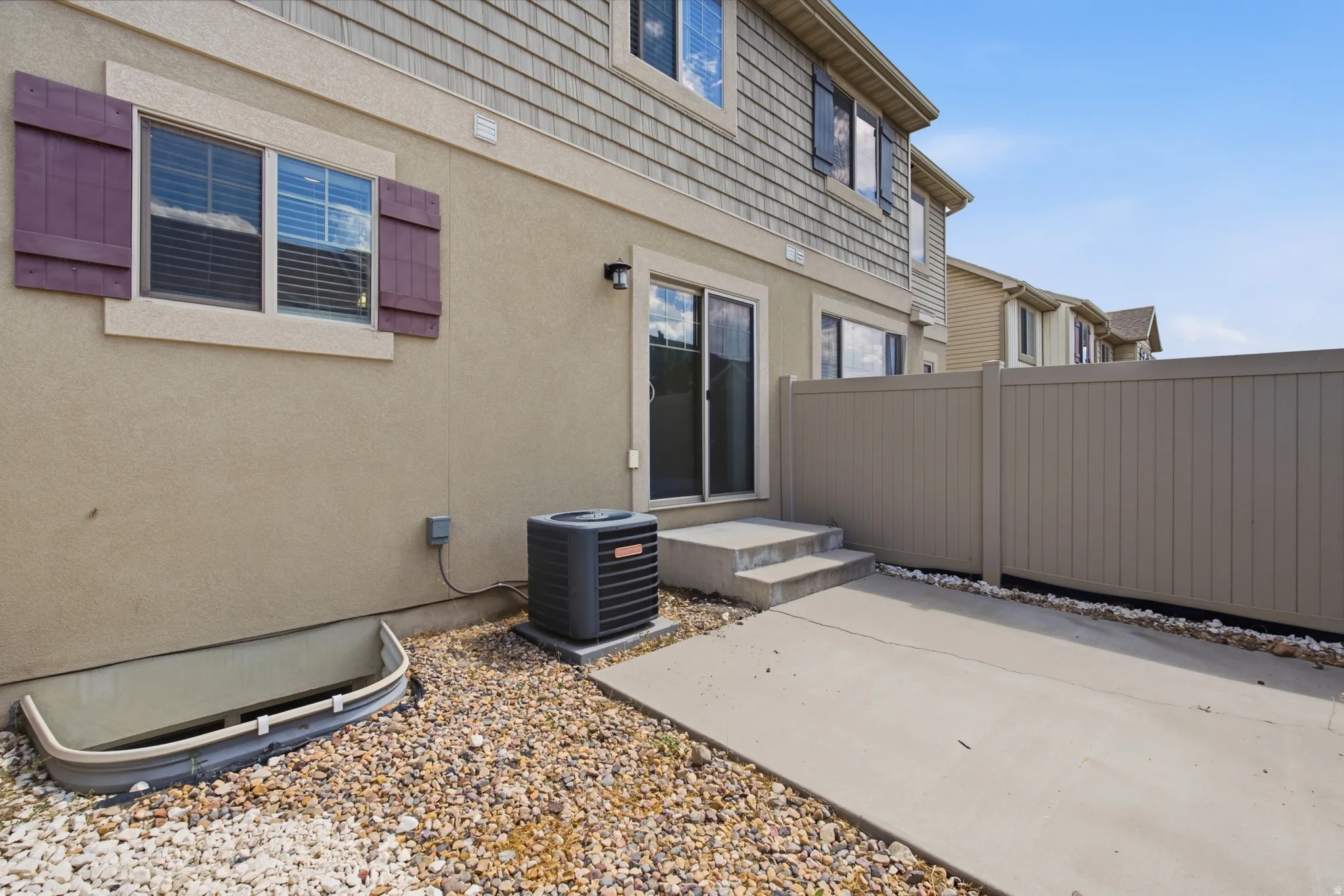 Rear exterior featuring stucco and siding finishes
