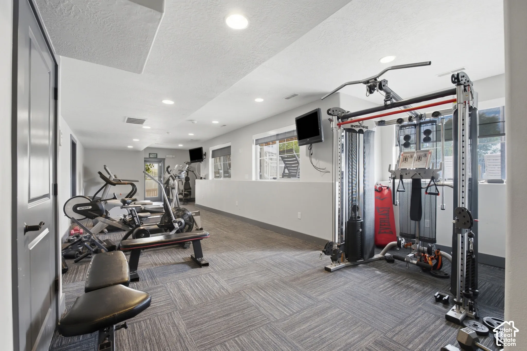 Dedicated fitness room featuring recessed lighting and patterned carpet flooring