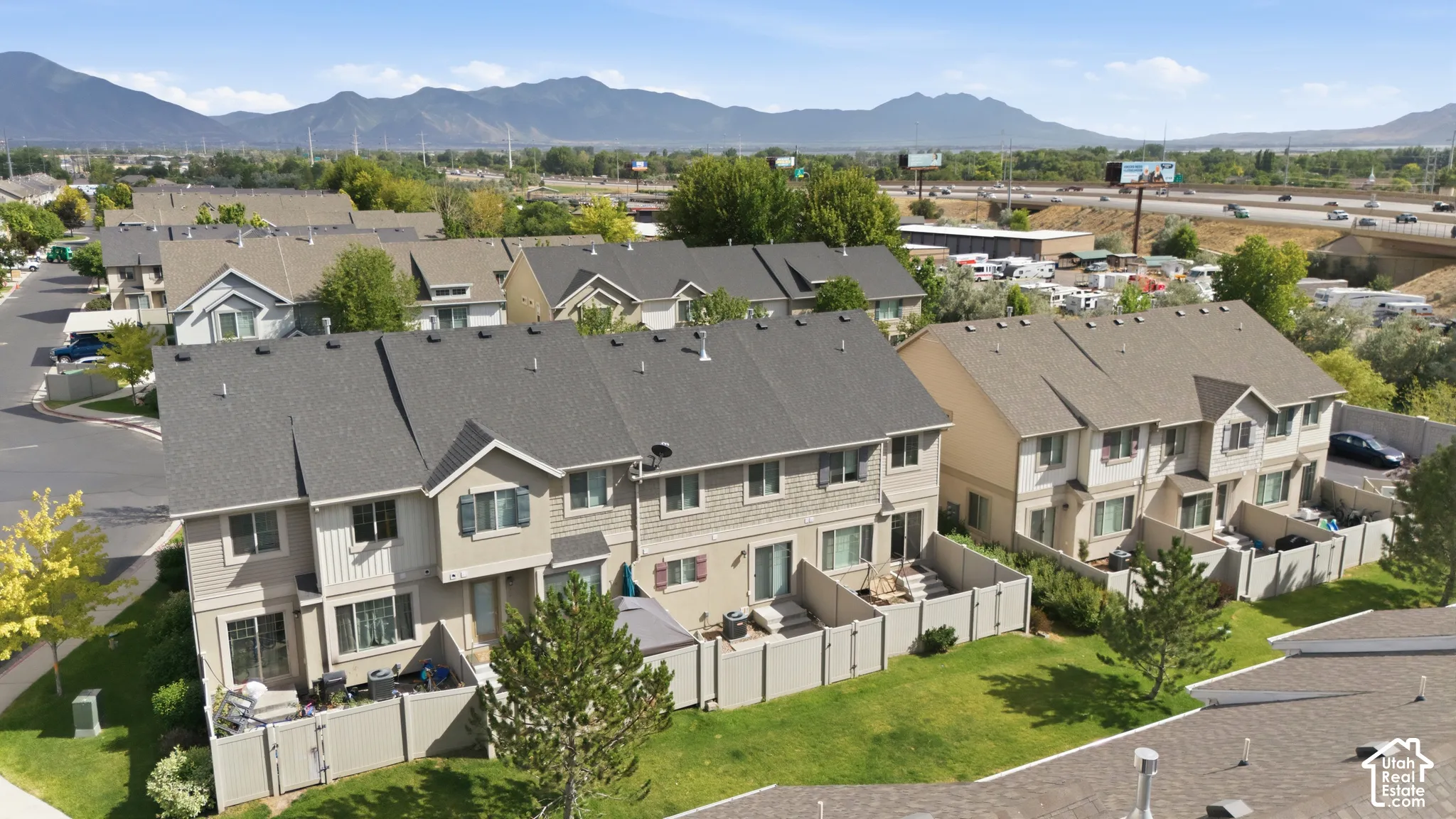 Townhome exterior with shingle roofing and mountain scenery