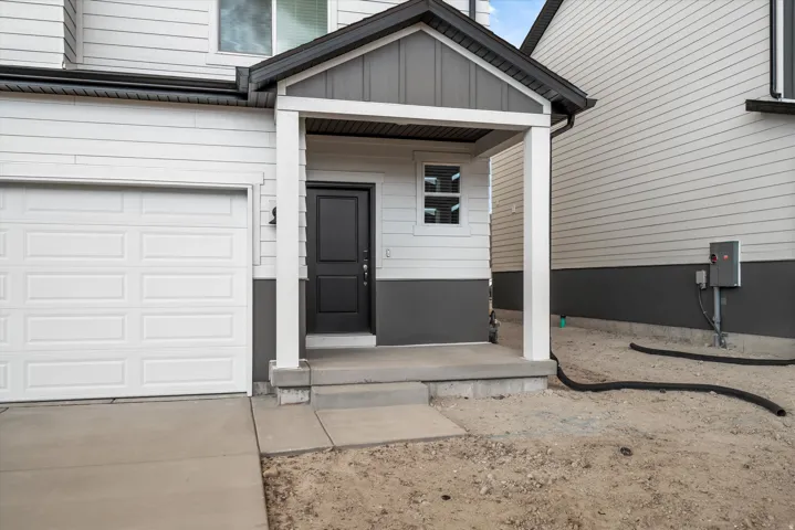 *DISCLAMER* Elevation may vary. Two-story exterior with light-colored siding and a dark foundation