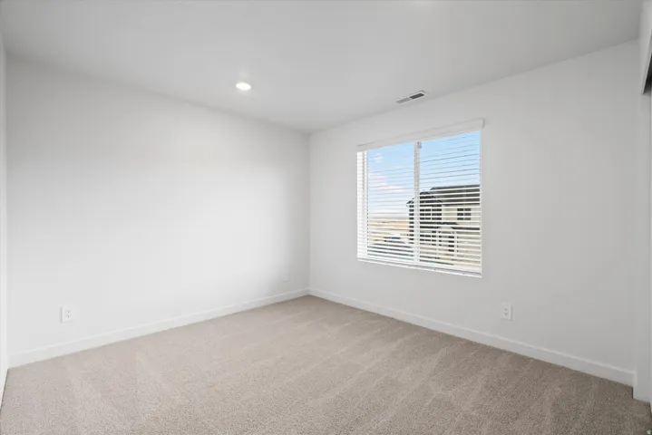 Neutral-toned carpet flooring and white painted walls