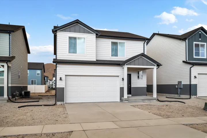 *DISCLAMER* Elevation may vary. Contemporary two-story residence featuring a two-tone exterior with white siding and dark gray accents