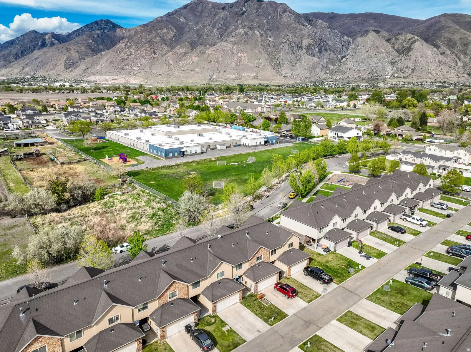 Aerial perspective showcasing a residential community with prominent mountain backdrop