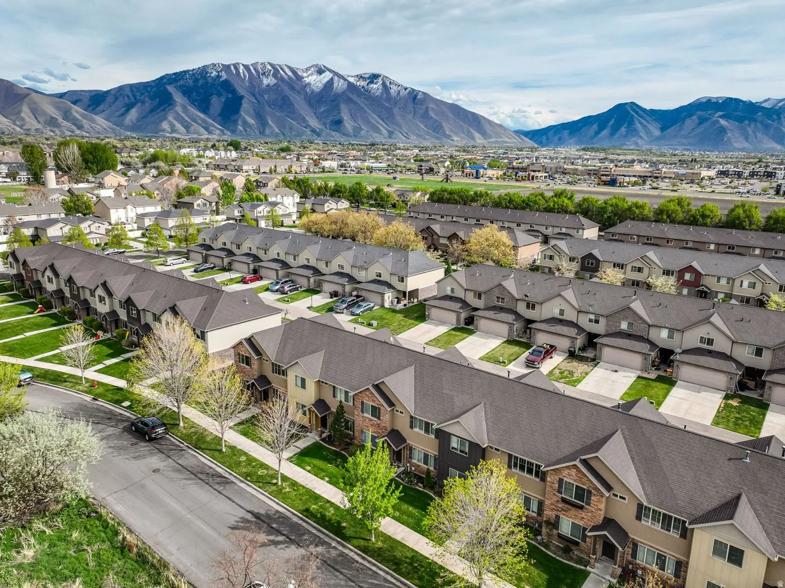 Aerial perspective showcasing a community of townhomes with mountain scenery