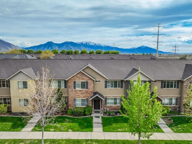 Contemporary townhome exterior featuring stone and siding finishes