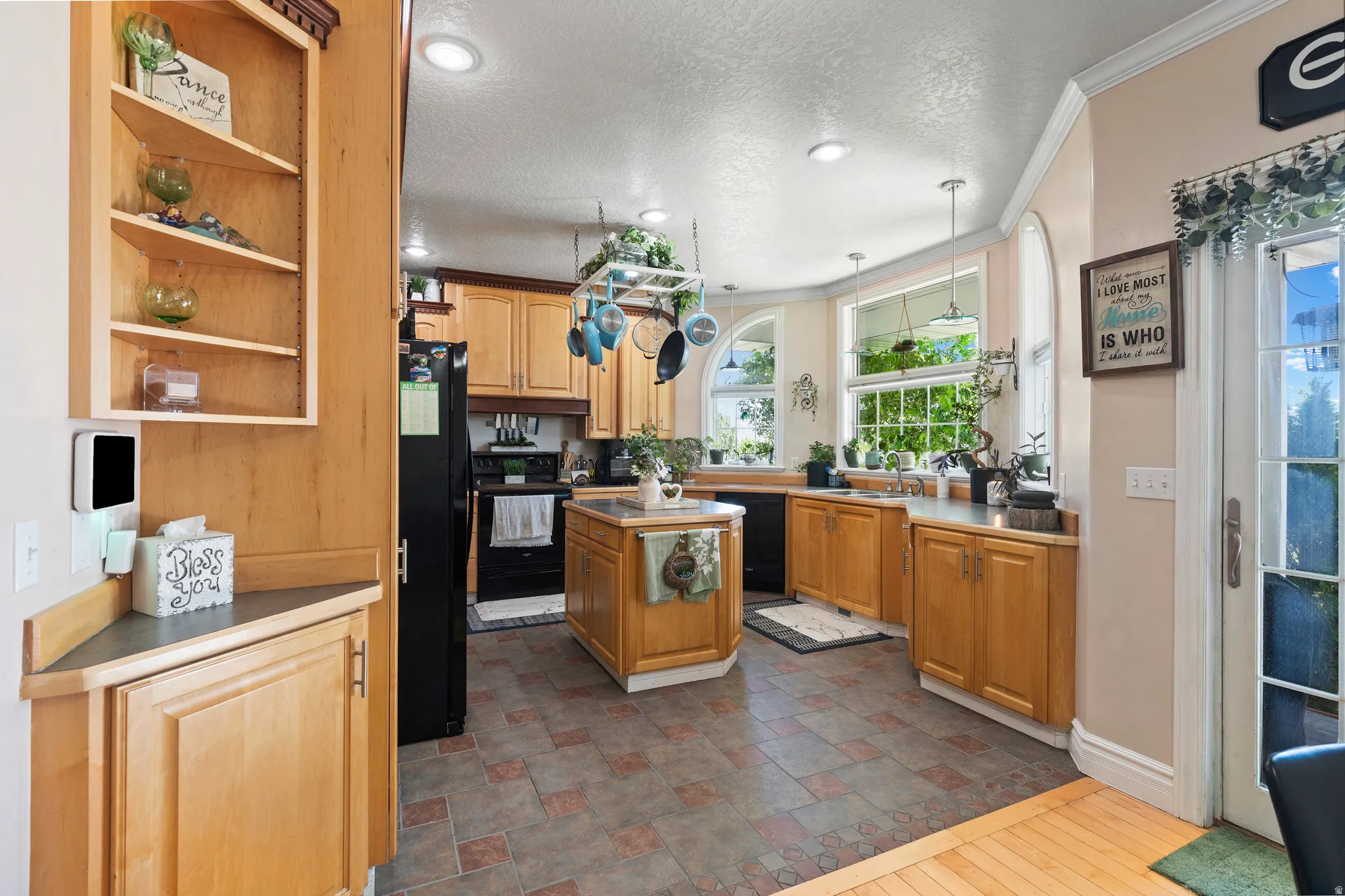 Kitchen featuring light wood cabinetry, a central island, recessed lighting, and a tiled floor