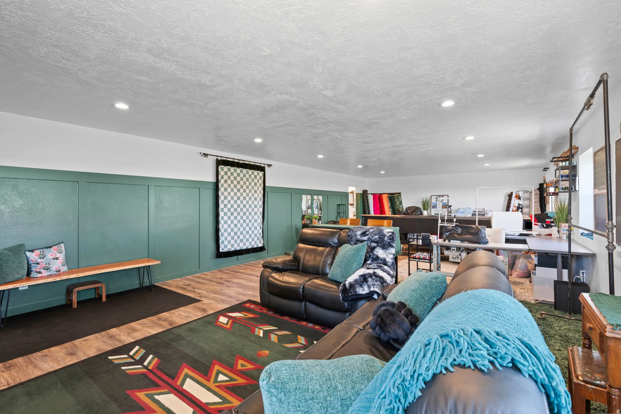 Spacious interior featuring wood-finish flooring and a paneled accent wall