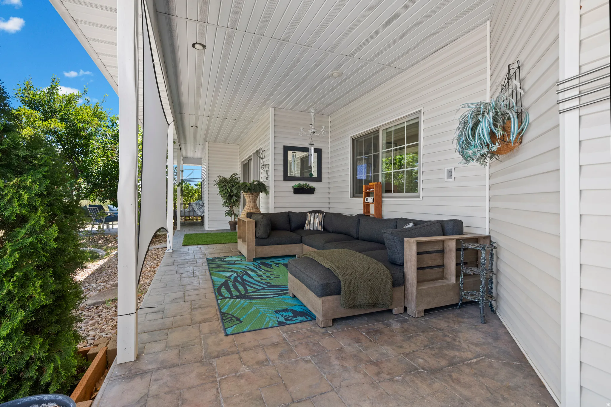 Covered patio featuring a stamped concrete floor, white vinyl siding, and a beadboard ceiling with recessed lighting