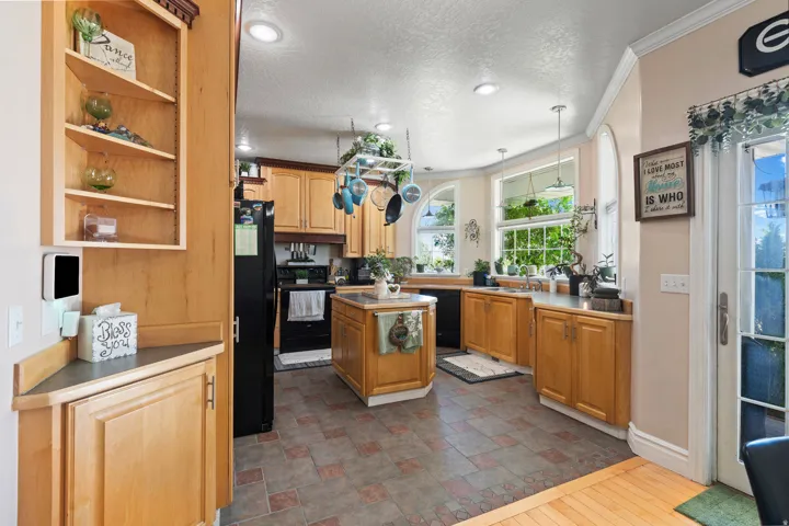 Kitchen featuring light wood cabinetry, a central island, recessed lighting, and a tiled floor