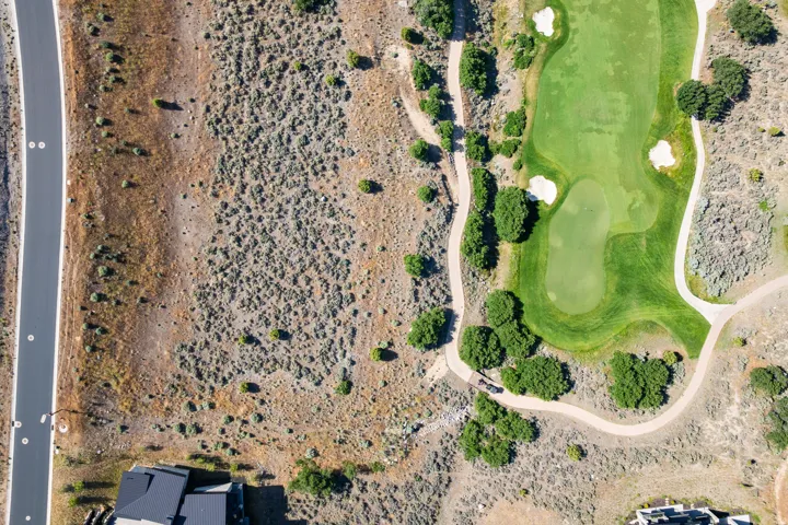 Aerial perspective showcasing a verdant golf course with sand traps and cart paths