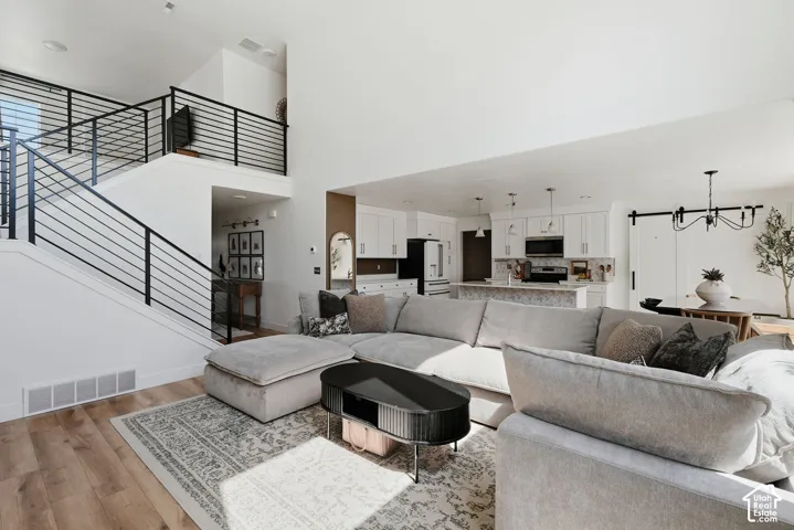 Open-concept living area featuring high ceilings and wood-finish flooring
