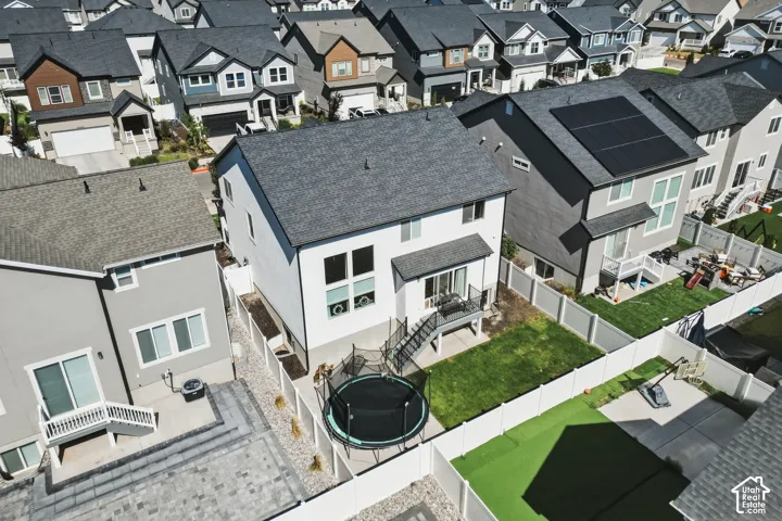 Two-story residence featuring a white vertical siding exterior and a dark shingle roof