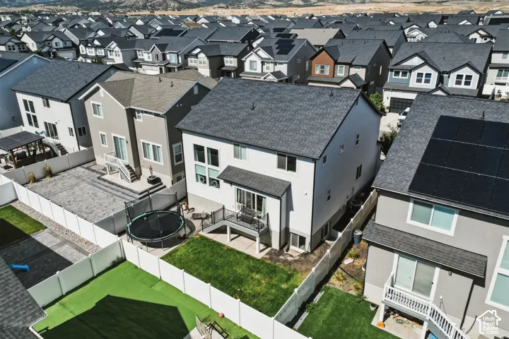 Rear exterior with a ground-level patio and a white vinyl fence