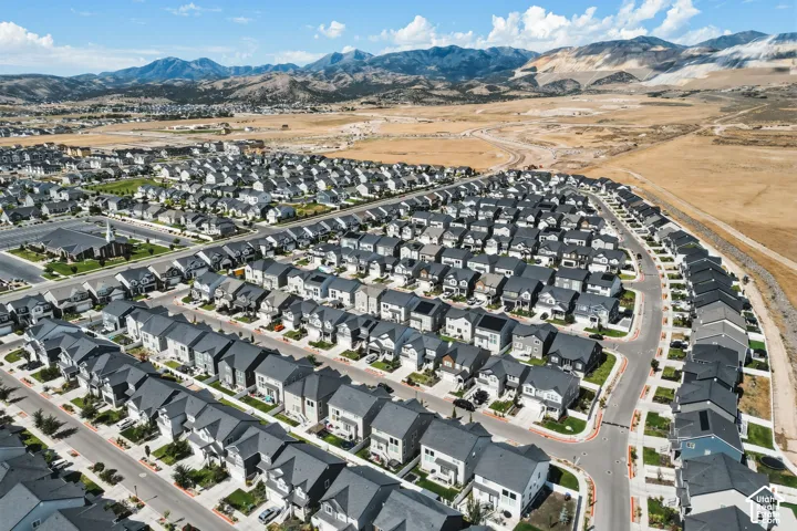 Expansive residential development featuring uniform grey roofs and varied home exteriors