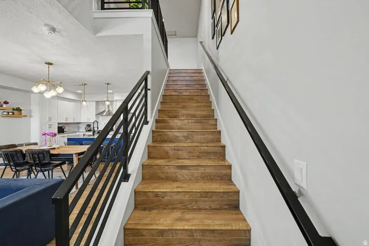 Wood-finish staircase with black metal railings