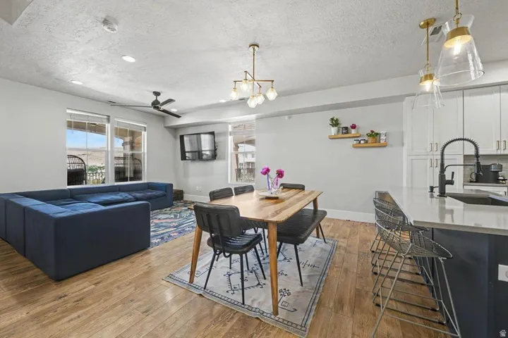 Open concept living space featuring wood-finish flooring, recessed lighting, and a ceiling fan