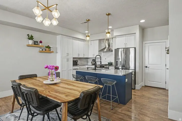 Modern kitchen and dining area featuring wood-finish flooring
